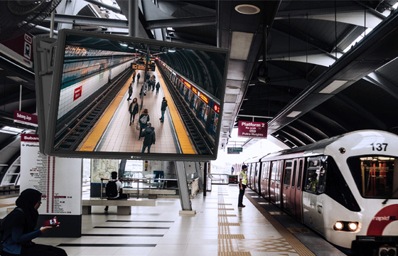 AG Neovo 4K security monitor is ceiling mounted in the train station.