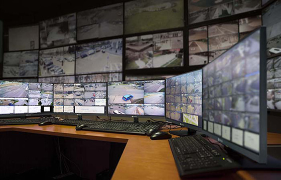 AG Neovo security monitors are placed on the desk in the control room.